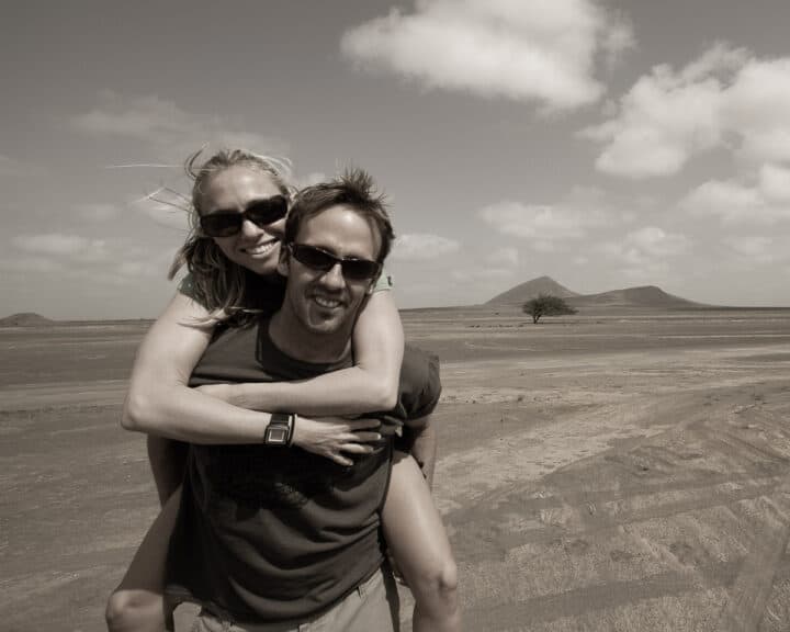couple holding and smiling to the camera